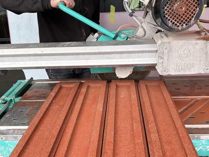 Cutting balusters to length on the wet saw.