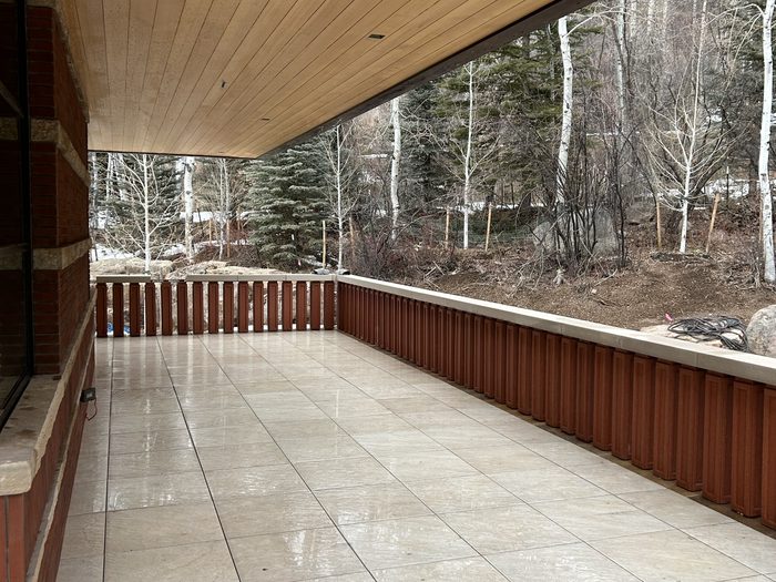 Finished balcony — balusters and stone handrail caps set, floor polished.