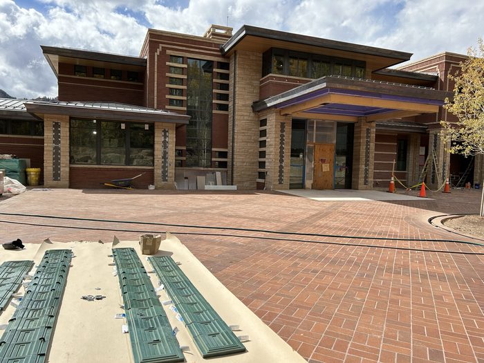 Green terracotta inlay strips laid out on the pavers, ready to set into the pillars.