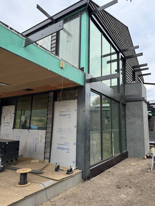Insulation and raw steel framing around window openings.