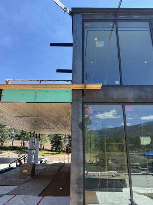 Steel beam overhang wrapped for protection during install.