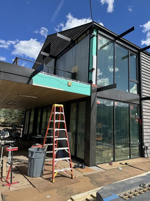 Steel beams and headers forming a covered outdoor area.