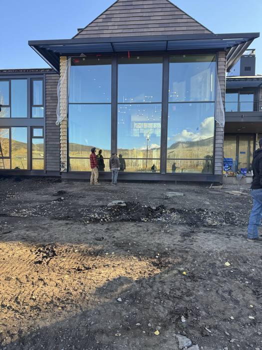 Low angle of the glass curtain wall and structural steel framing.