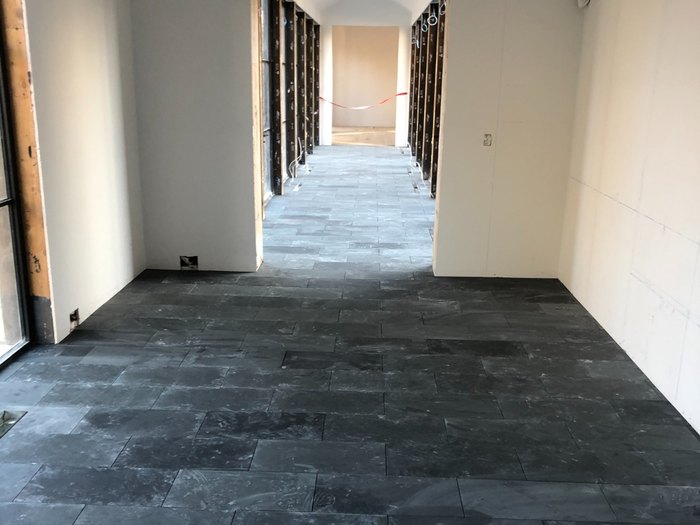 Finished slate running the full length of the gallery and on through the hall beyond.