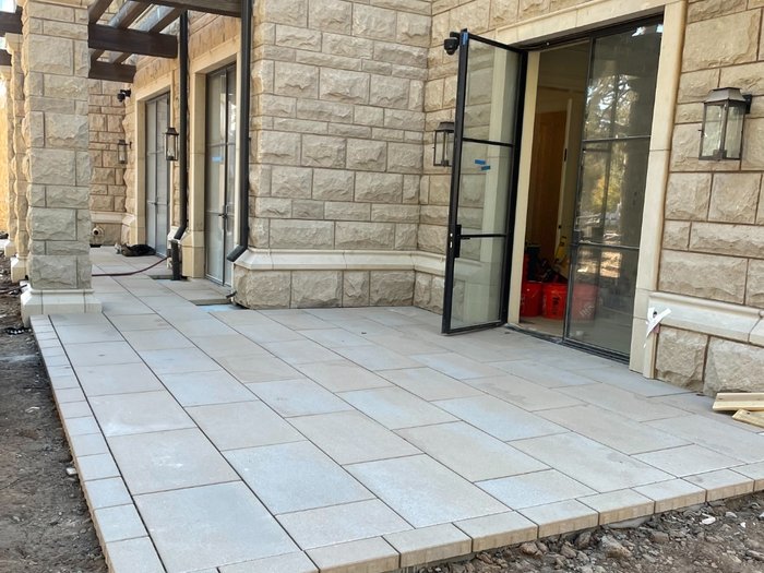 Finished terrace wrapping the corner of the residence — full field, borders, and door transitions.
